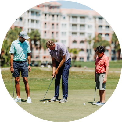 Two men and a boy on putting green